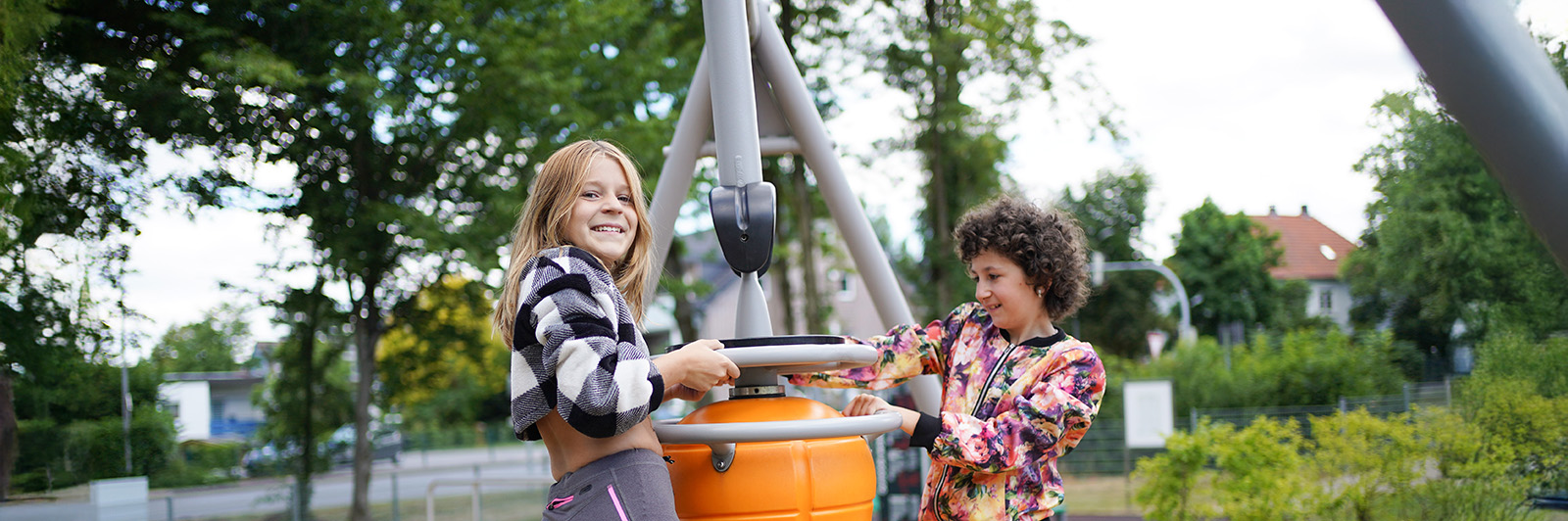 Two girls swinging on an Agito swing.